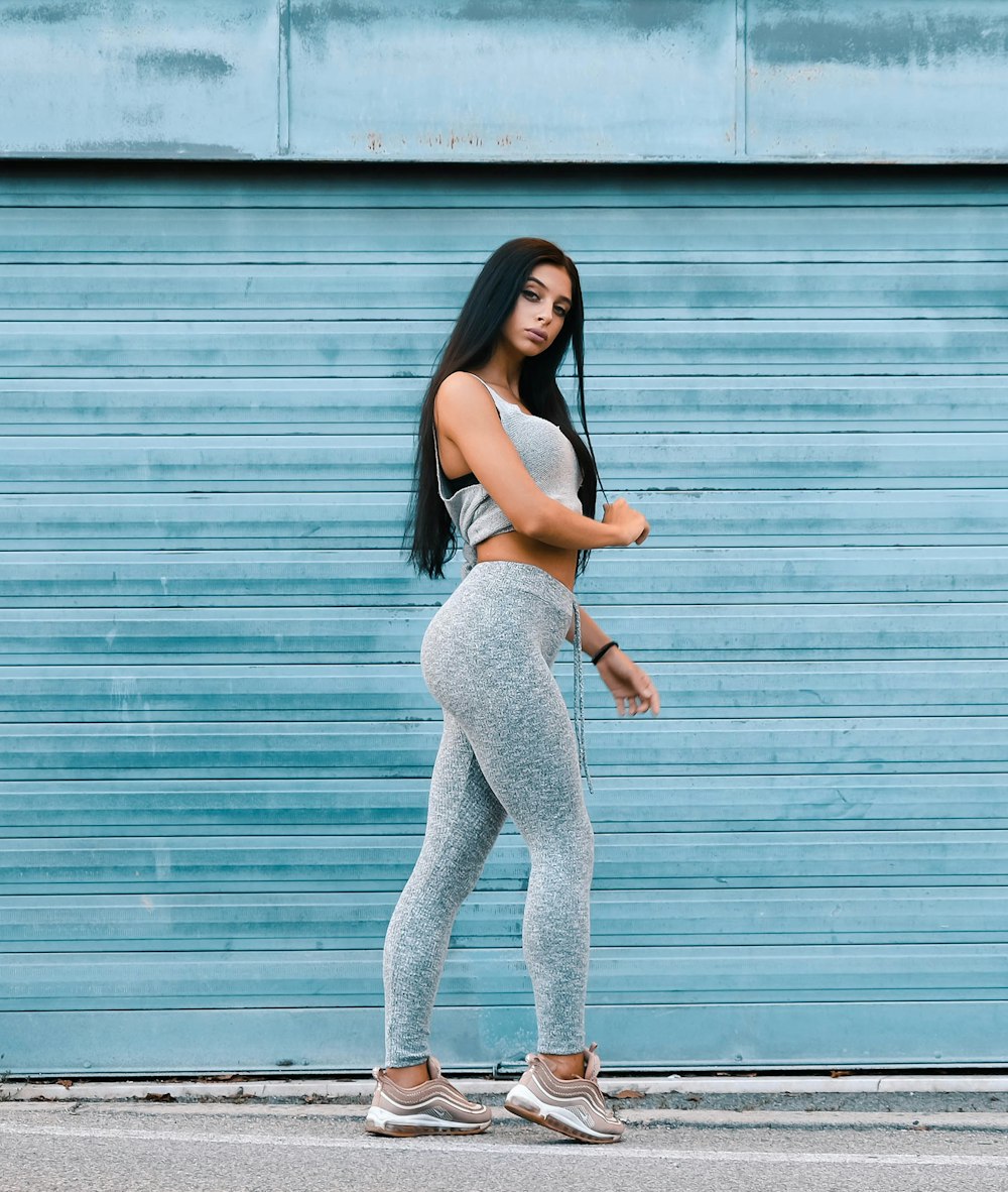 woman standing near blue metal roll-up door