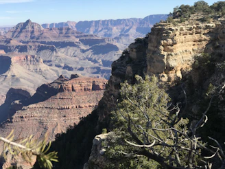 A scenic view of the Grand Canyon with a helicopter flying above.
