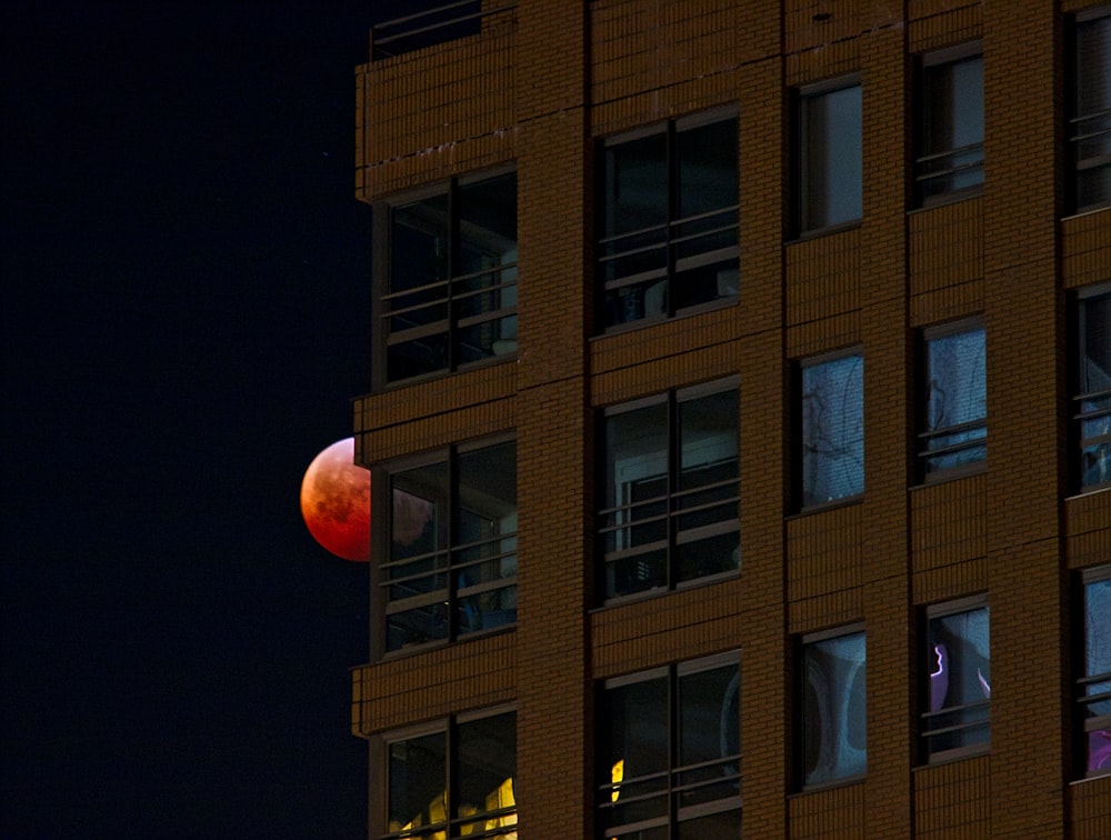 view of Earth's blood moon with brown concrete building