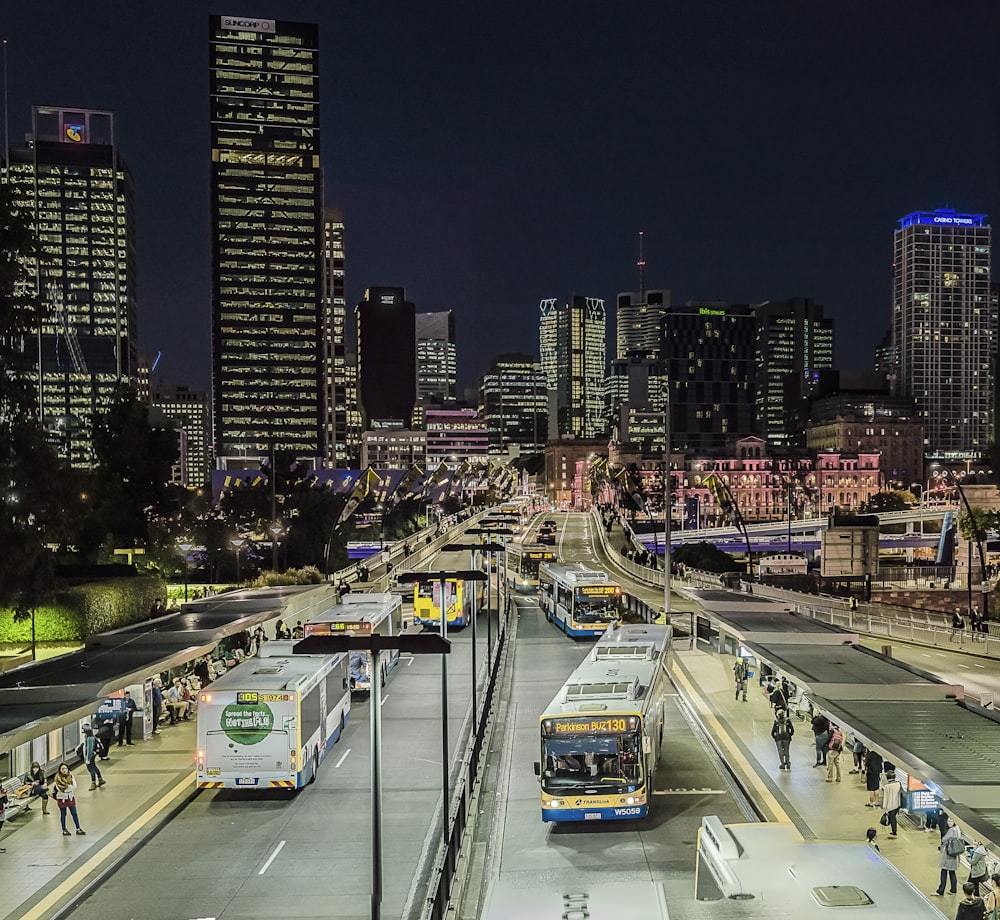 lighted city with busy street and high-rise buildings