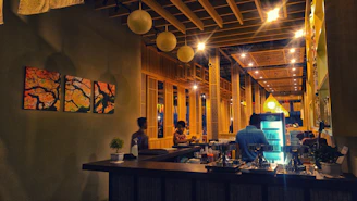 A cozy restaurant bar interior with modern point of sale terminals and ambient lighting.