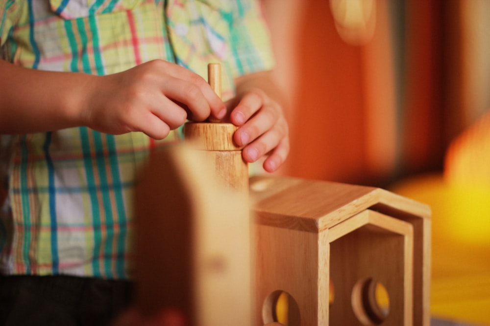 person playing wooden stackables