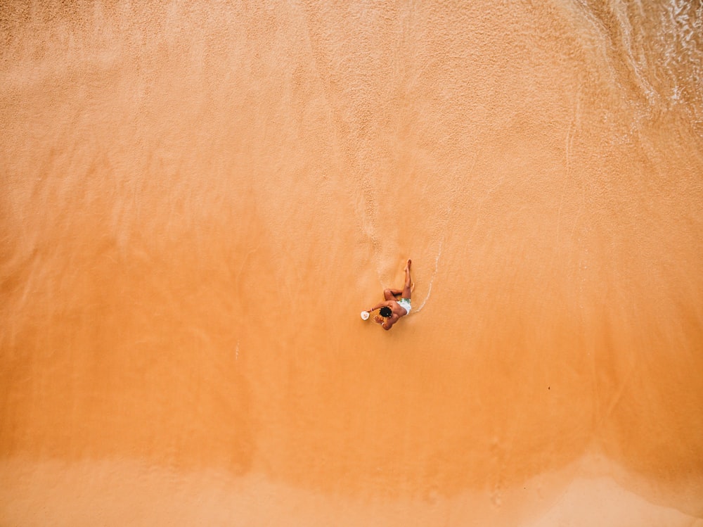 man sitting on seashore