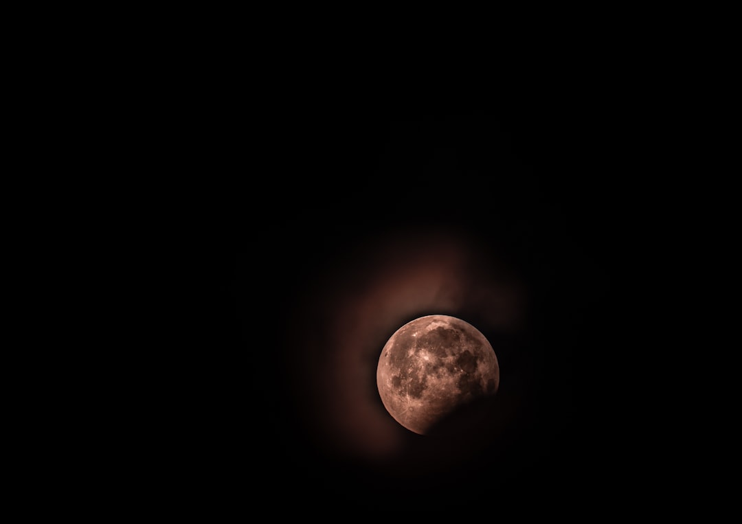moon surrounded by black background, super blood wolf moon 2019