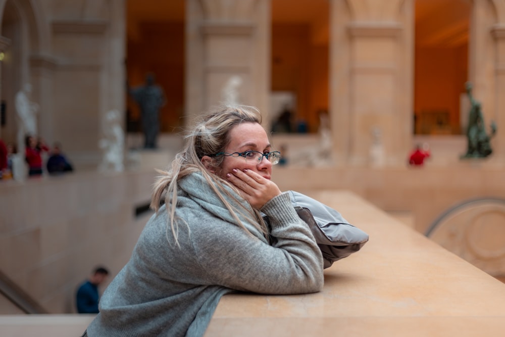 selective focus photography of woman wearing gray jacket