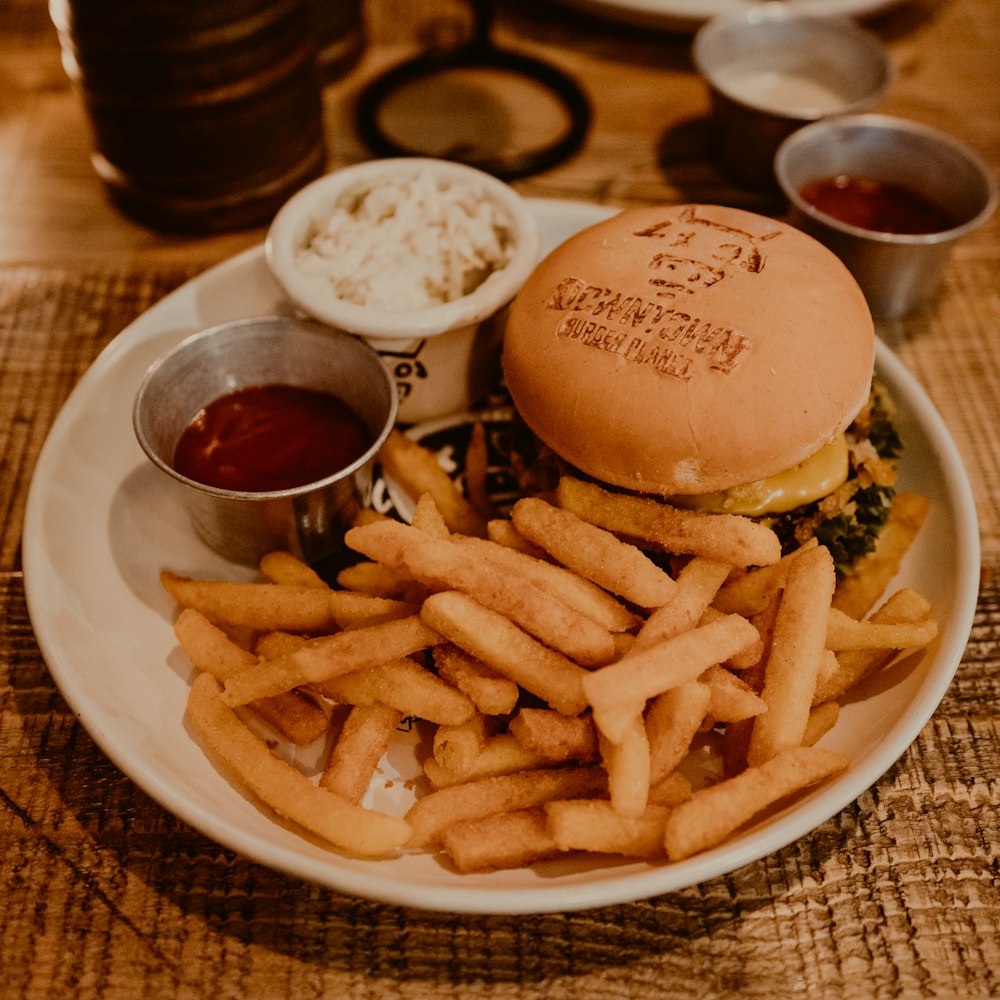hamburger and fries on white plate