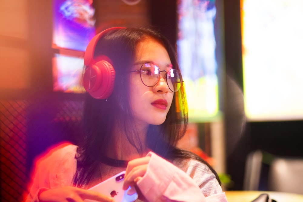 woman wearing red wireless headphones