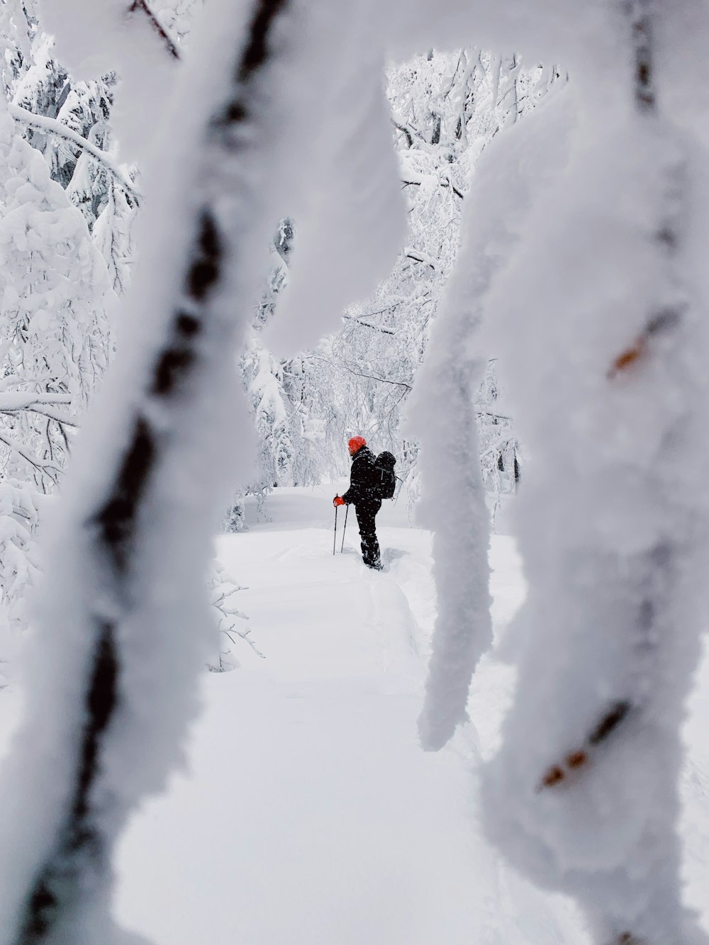 man standing on snow capped ground during daytime