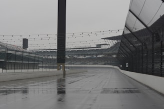 Empty racetrack under a cloudy sky, waiting for the next horse race.