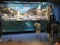 A group of people stands observing a large aquarium exhibit. The exhibit features a rocky landscape with water visible on the lower half. A person behind the glass is interacting with the exhibit, possibly a trainer or staff member. The environment suggests an indoor setting, and the atmosphere appears educational and engaging.