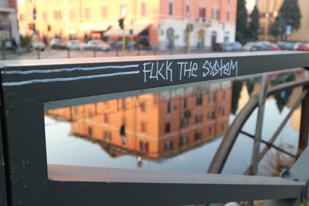 black railing across river from brown building