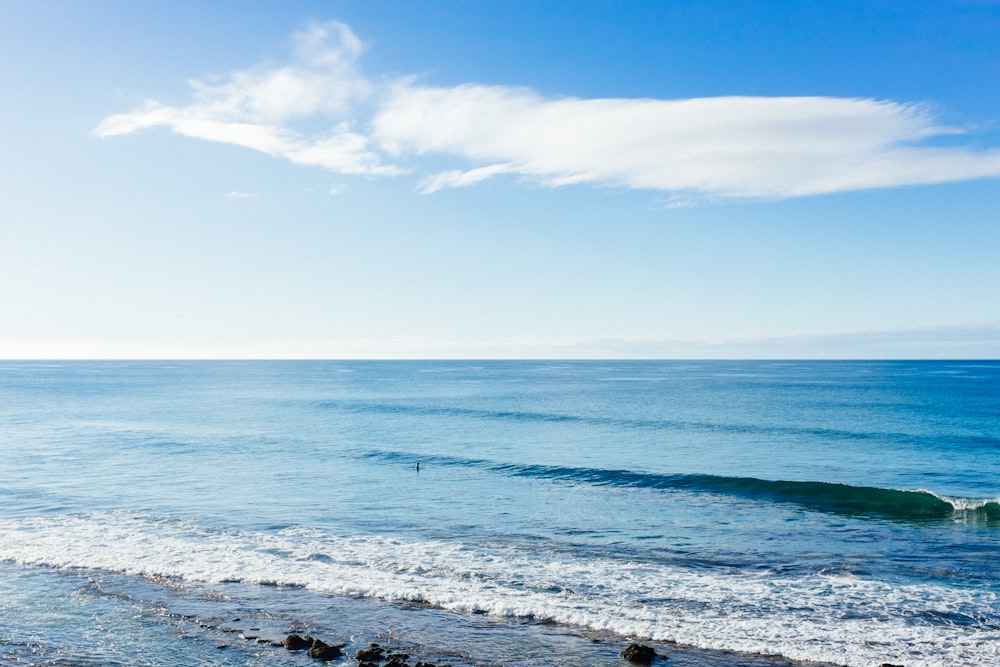 white clouds in blue sky over tranquil beach