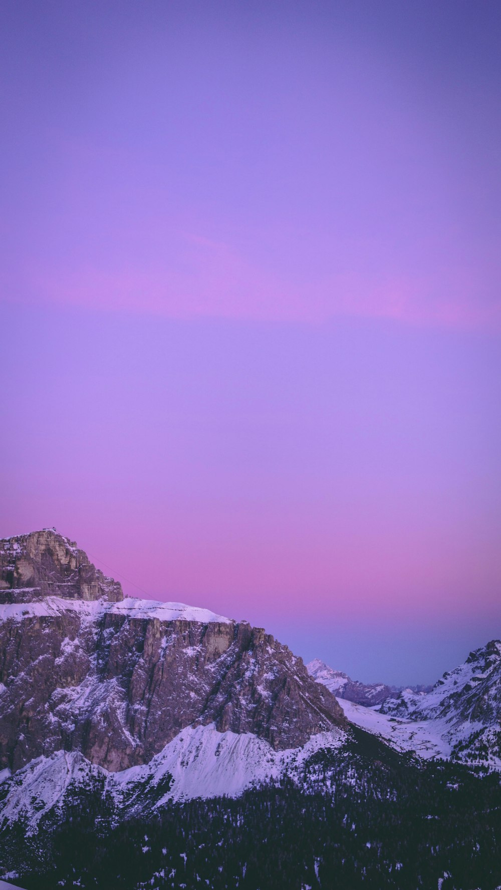 snow covered rocky mountain during daytime