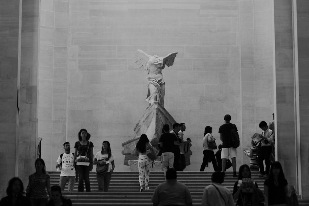 grayscape photography group of person walking on stair