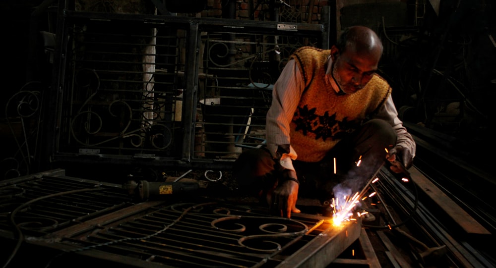 man holding welding rod