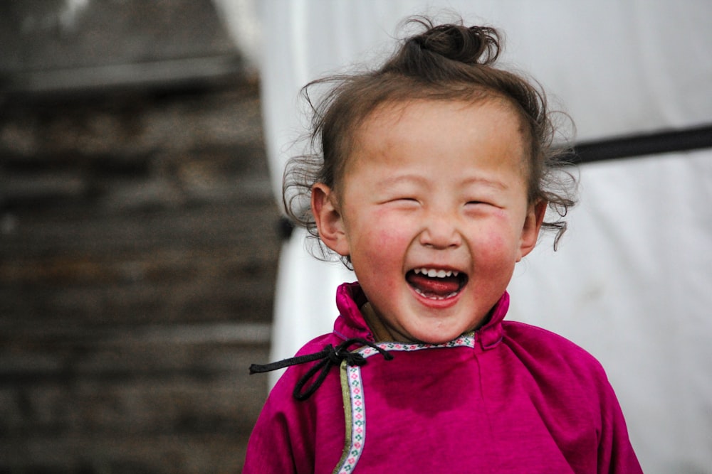 smiling girl wearing pink dress