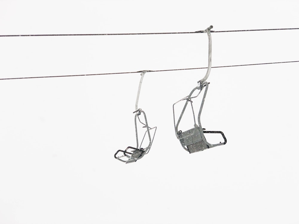 a couple of ski lifts hanging from a wire