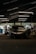 A team of technicians collaborating on vehicle performance upgrades in a modern garage.