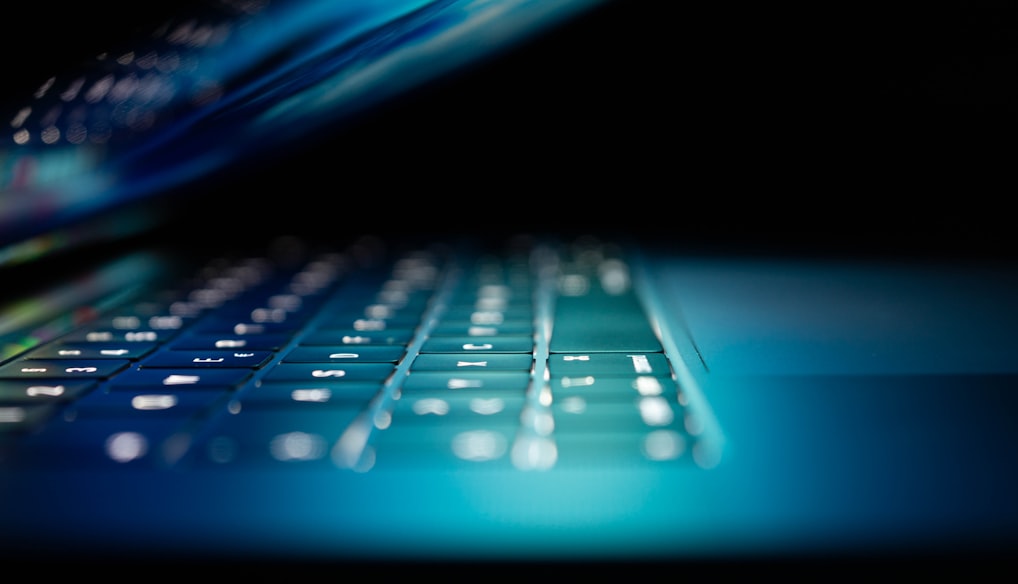 closeup photo of turned-on blue and white laptop computer