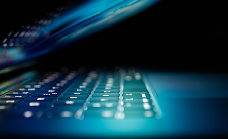 closeup photo of turned-on blue and white laptop computer