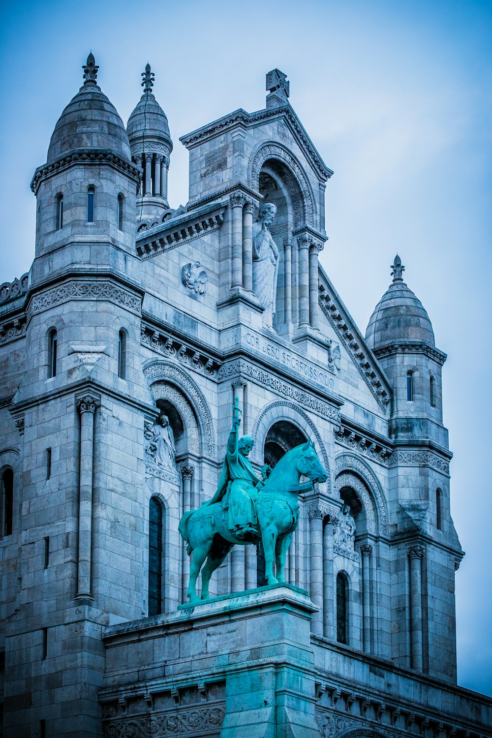 blue man on horse statue in front of cathedral