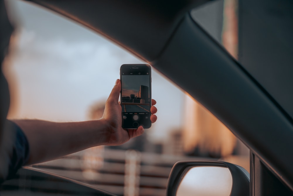 person taking selfie while riding vehicle