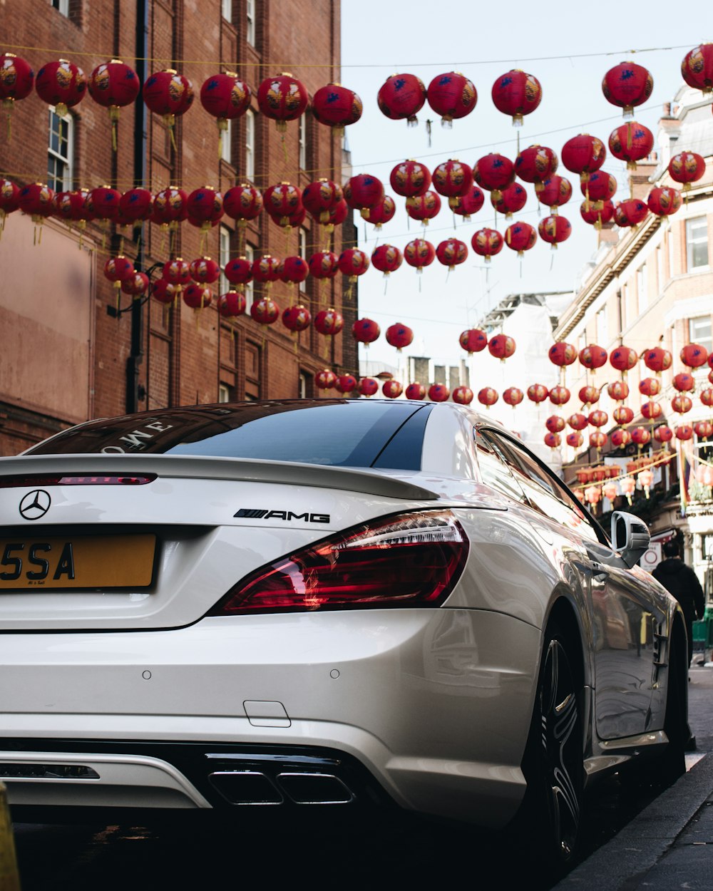 white Mercedes-Benz coupe parking on street