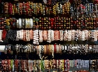 An assortment of gold bracelets stacked together, showcasing various styles.