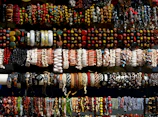 A collection of trendy bracelets displayed on a soft fabric.
