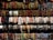 An assortment of colorful bracelets arranged in rows. The bracelets feature various designs and materials, including beads, shells, leather, and woven patterns. The display suggests a vibrant and diverse collection, showcasing a range of artistic styles.