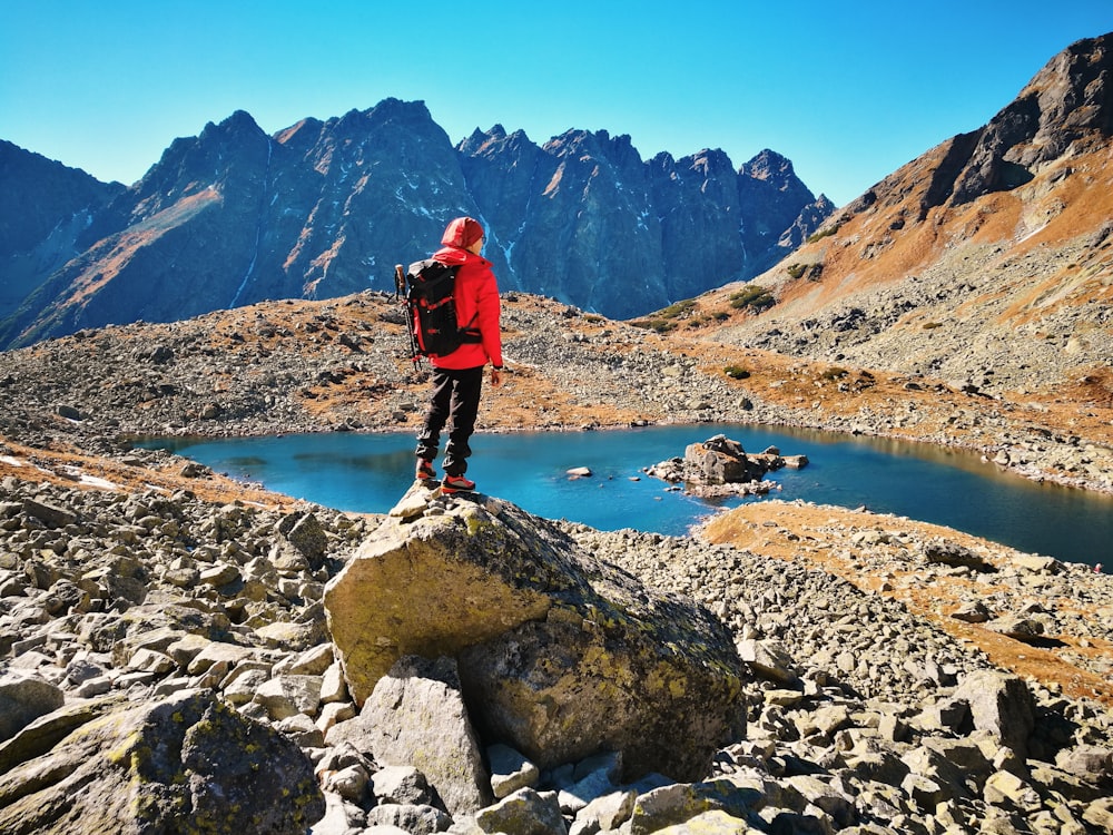 man standing on rock during daytime