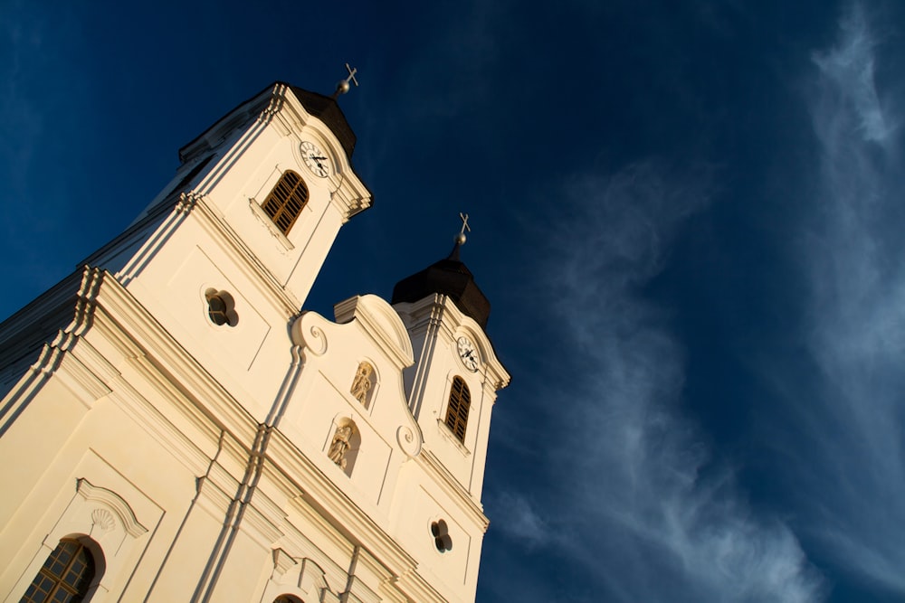 low angle photo of white cathedral under blue sky