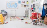 A candid shot of a cluttered yet warm home workspace with children’s drawings scattered around.