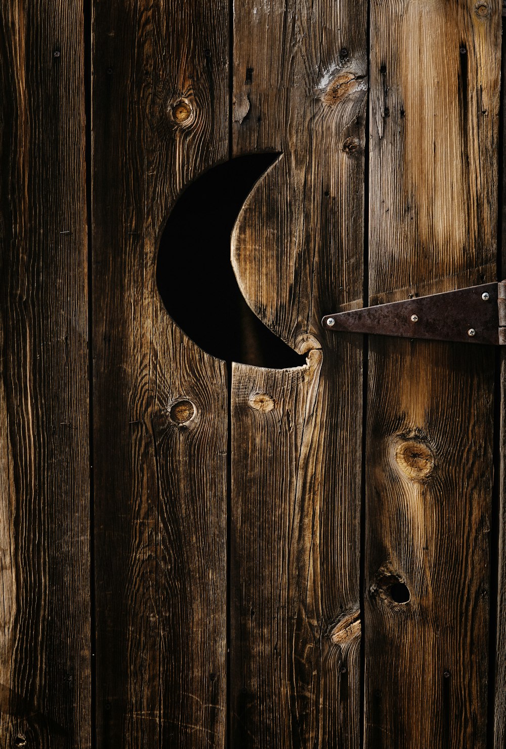 a close up of a wooden door with a metal handle