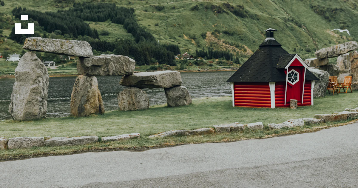 Red and black wooden house beside rock formation photo – Free Building ...