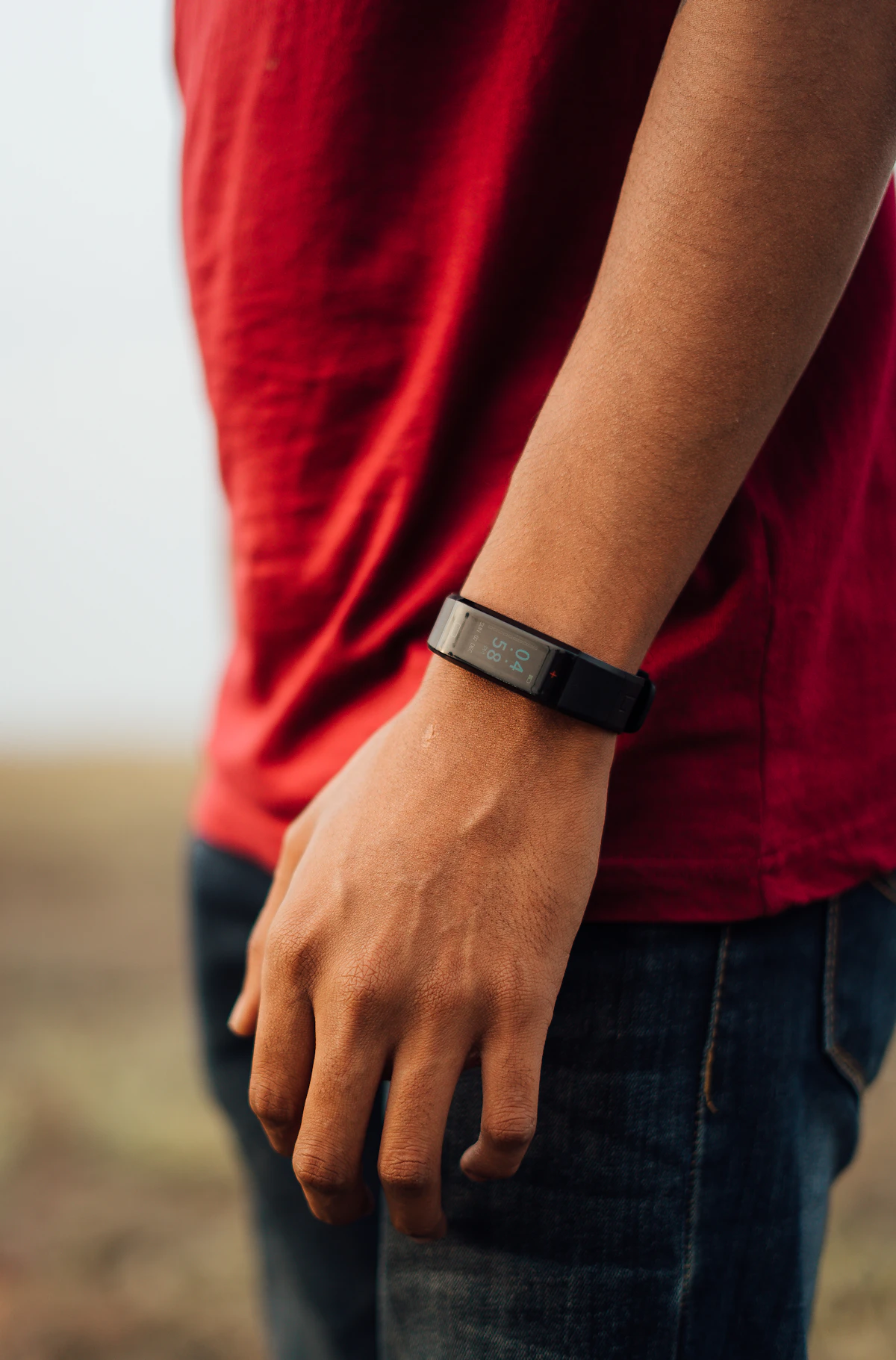 Slim black fitness tracker worn on a person’s wrist