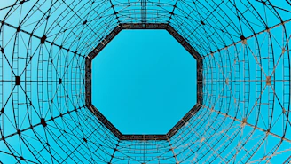 low angle photo of blue sky under circular tower