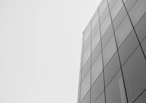 Modern office building facade featuring sharp angles and reflective glass panels