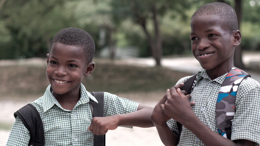 Two young students in school uniform smiling