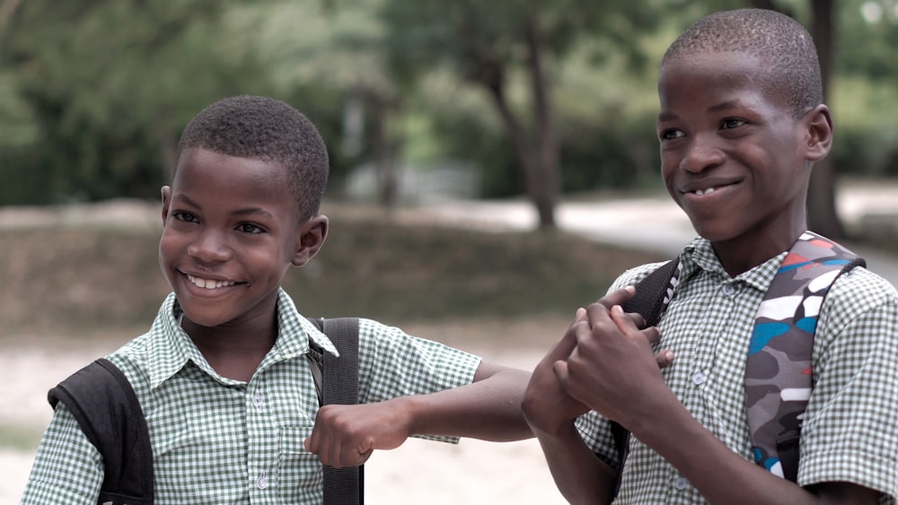 2 smiling boys in uniform