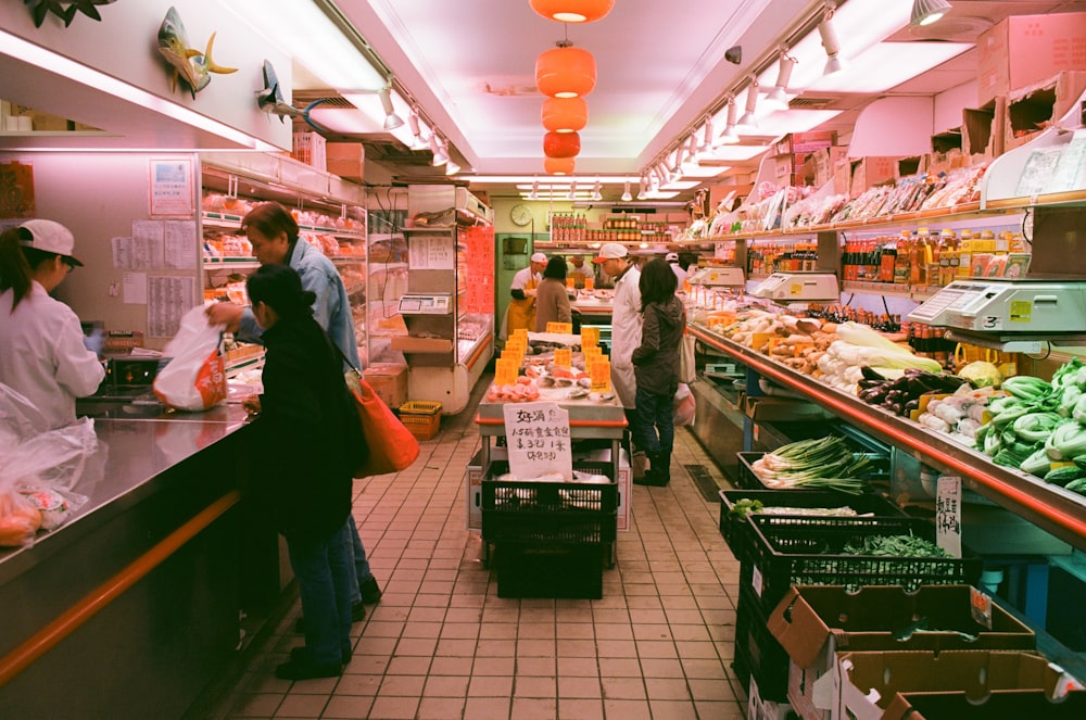 man stands beside man in front of cashier in store