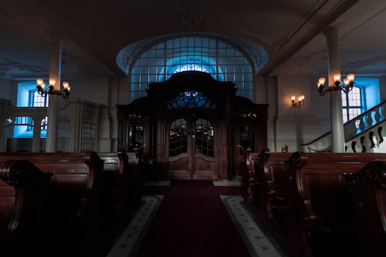 A dignified, classical Masonic lodge hall bathed in warm light, showcasing ancient symbols and rich woodwork.