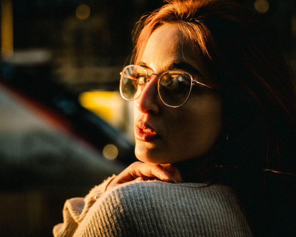 selective focus photography of woman wearing gray sweater