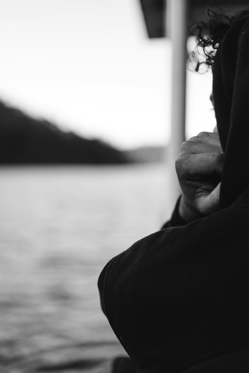 grayscale photography of person facing at beach