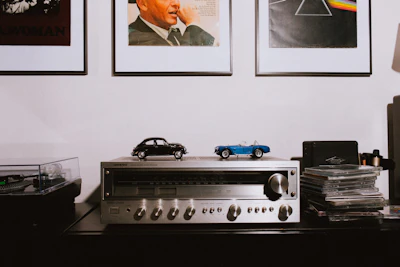 gray AV receiver on brown wooden table