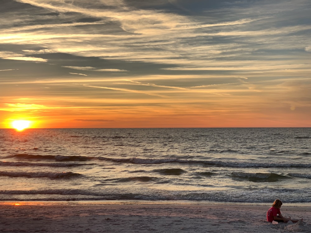 people sitting on seashore