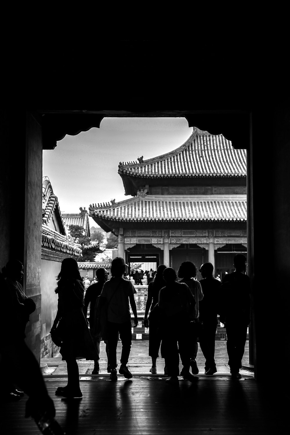 silhouette photo of people near pagoda temple