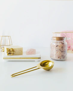 Elegant arrangement of organic bath salts and effervescent bombs with soft natural lighting.