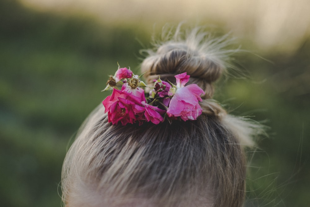close-up photo of girl with flower bun on hair