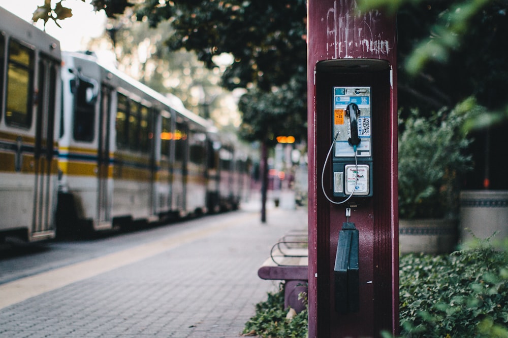 phone booth near train during day time